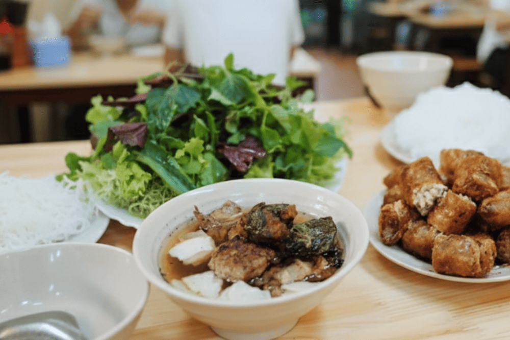 Delicious grilled pork with crispy crab spring rolls, perfectly balanced by the tangy dipping sauce and pickled veggies